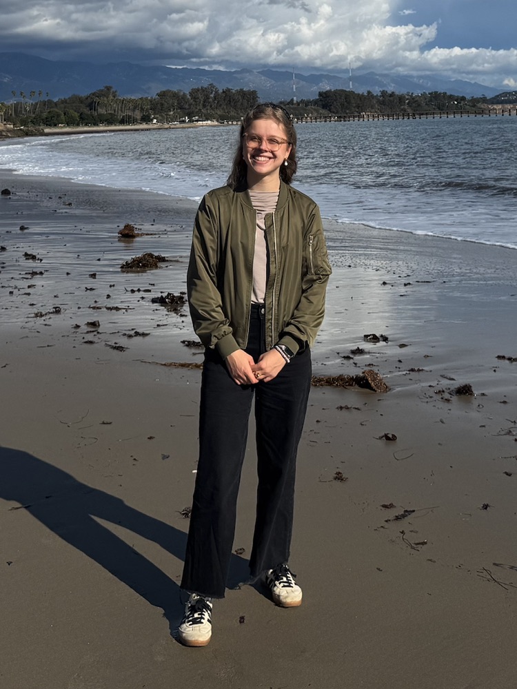 Johanna Müller-Horn standing on a beach by the ocean